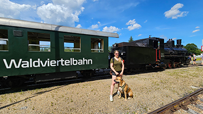 Frau mit Hund steht vor der Waldviertelbahn